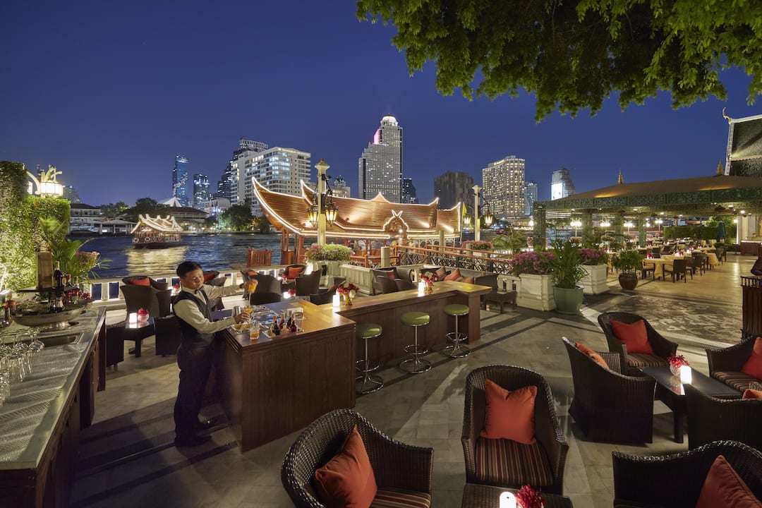 terrace rim naam outdoor with river view at night at mandarin oriental, bangkok